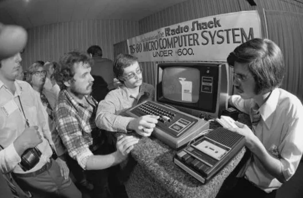 Radio Shack flaunts their new  TRS-80 Micro Computer System, circa 1977. 
